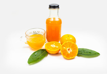 Fototapeta na wymiar Glass of orange juice with bottle on white background. Fruit for health