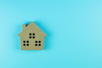 Top view house model on blue background with copy space for text. Banking, real estate, investment, financial, savings concepts