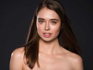 Naklejka premium Beautiful woman face natural skin hair Studio shot of a beautiful young woman posing against a black background