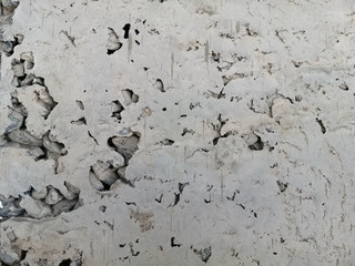  texture of hollow concrete has a honeycomb structure called Honeycombing, usually occurring on the surface of poured concrete with closed form. Grungy rough cement wall. 