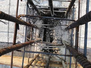 The steel bars are woven into a square and tied with wire for pouring concrete in construction site.