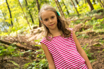 Fototapeta premium Smiling girl posing for a photo in nature