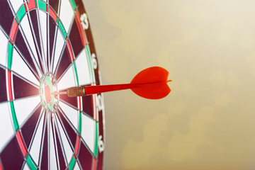 A red dart in a bulls eye target