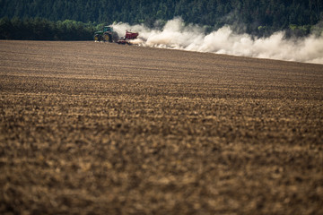 Tractor plowing a dry farm field