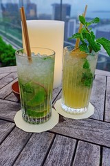 A glass of mojito with dried lime and fresh mint