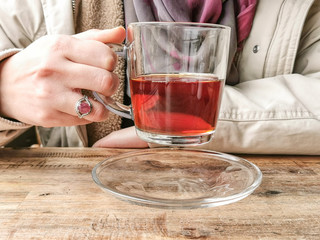 Teen Girl Hand with Limestone Ring holding a Tea Cup while seating in a Restaurant or Coffee Shop | Resto cafe Table