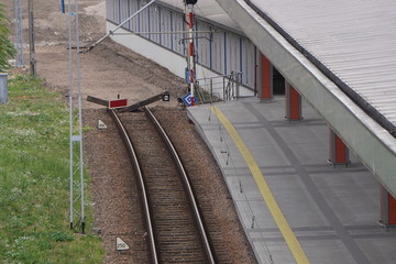 Railway tracks for a tram or train at the platform in Europe on sunny day.