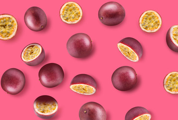 pattern with passion fruits and slices on a pink background