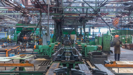 Conveyor assembly stage the body of tractor at factory timelapse