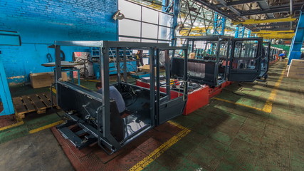 Fototapeta na wymiar Conveyor assembly stage the body of tractor at factory timelapse