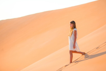 Girl among dunes in Rub al-Khali desert in United Arab Emirates