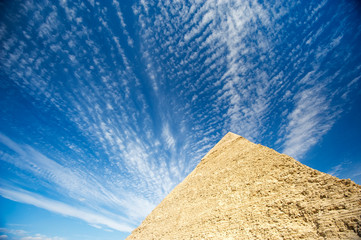 Fototapeta na wymiar Blue sky view of the Great Pyramid with dramatic cloudscape in Giza, Egypt