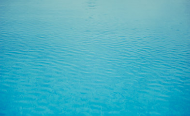 Background texture of blue water in the outdoor pool in a tropical resort