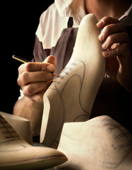 Italian Shoes designing, closeup on hands. High Italian craftsmanship