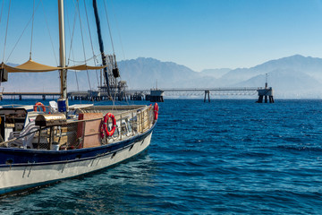 Obraz premium yacht in the sea against the backdrop of mountains