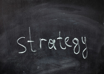 Obraz premium concept, word Strategy written in chalk on a black chalkboard