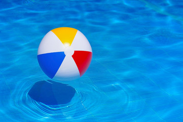 Colorful inflatable ball floating in swimming pool