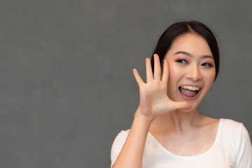 asian woman pointing, counting five finger; portrait of positive happy smiling asian woman pointing...
