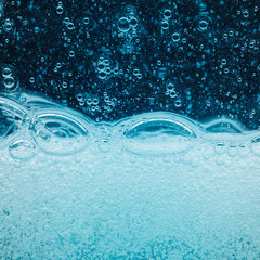 abstract liquid soap bubbles blue background