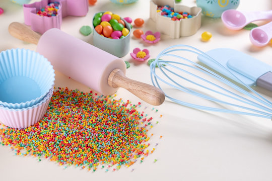 Baking and cooking concept. Cookie cutters, whisk, roller pin and kitchen bake tools for making sweets. Top view of a holiday baking still life. Sweet recipe cookbook.