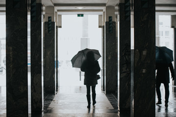 man walking in the rain with umbrella