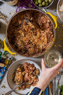 Festive New Year's Eve table with Pot of Cassoulet and Champagne.