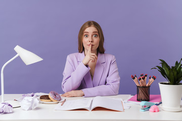Woman showing silence gesture.