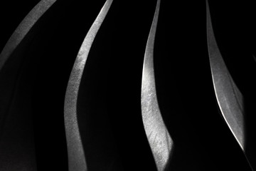 Dark background with silver steel blade, aircraft engine close up, part of a turbojet, modern...
