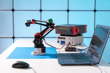 Model of a robot and a laptop on a table in a design office