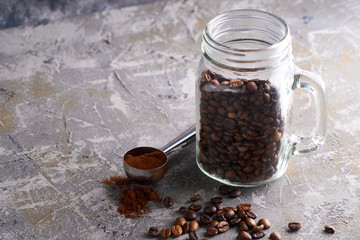 Coffee beans in a glass jar on a gray table