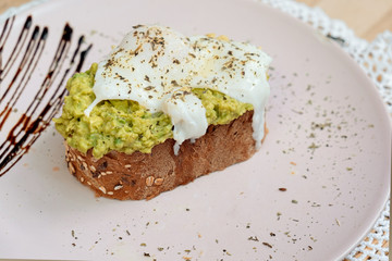 Whole wheat toasted bread with avocado and poached egg