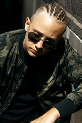 Obraz premium Closeup portrait of stylish boy with braids