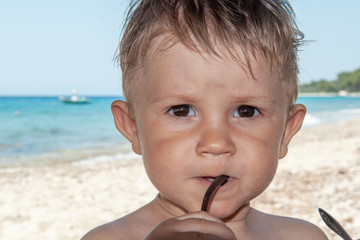  Kid play with sunglasses at the beach 