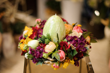 Easter egg made of ceramics in box with flowers