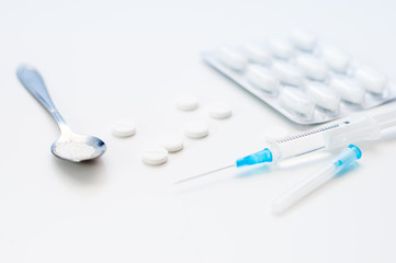 Tablets on a white background. spoon with white powder. drugs or Medicines for health, a banner for a hospital or clinic.