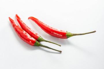 Three Fresh red peppers are isolated on white background.