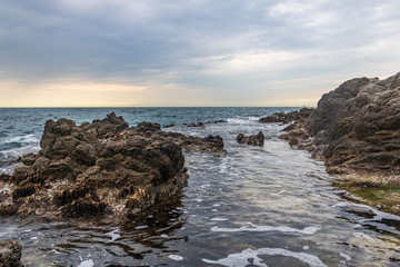 Nice landscape of rocks with calm sea and blue background in Costa Brava, Lloret de Mar