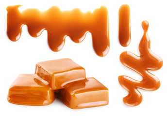 Caramel splashes and caramel candies isolated on white background. Spilled caramel sauce.