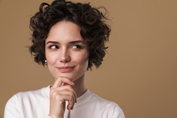 Image of thinking pleased woman posing and looking aside