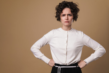 Image of annoyed caucasian woman posing and holding her hand on waist