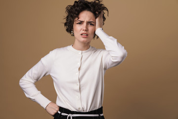 Image of unhappy caucasian woman with headache looking at camera