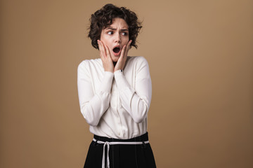 Image of scared beautiful woman expressing shock at camera