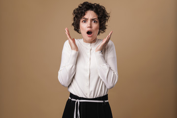 Image of scared beautiful woman expressing shock at camera
