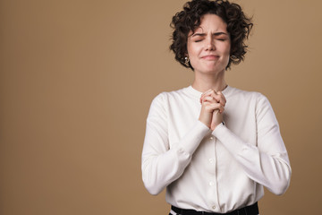 Image of nice beautiful woman posing and holding hands together