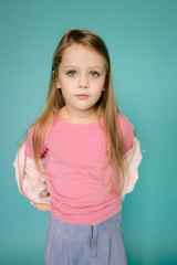 Fototapeta premium Studio model test of young girl. Lifestyle Studio portrait of young beautiful fashion girl. Emotional studio portrait of cute little girl. Portrait of smiling child