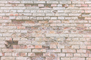 brick wall with holes of abandoned building located in historical city street