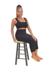 Lovely African woman sitting on a bar chair