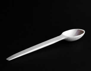 Wooden spoon. Cutlery. On a black background.