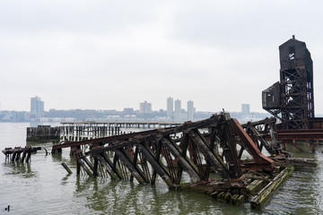 Fototapeta na wymiar Ruins of the 69th Street Transfer Bridge in the Hudson River of New York City on a Foggy Day