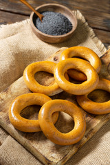 Bagels on a wooden plate on a brown wooden table. Rustic style. Homemade cake	